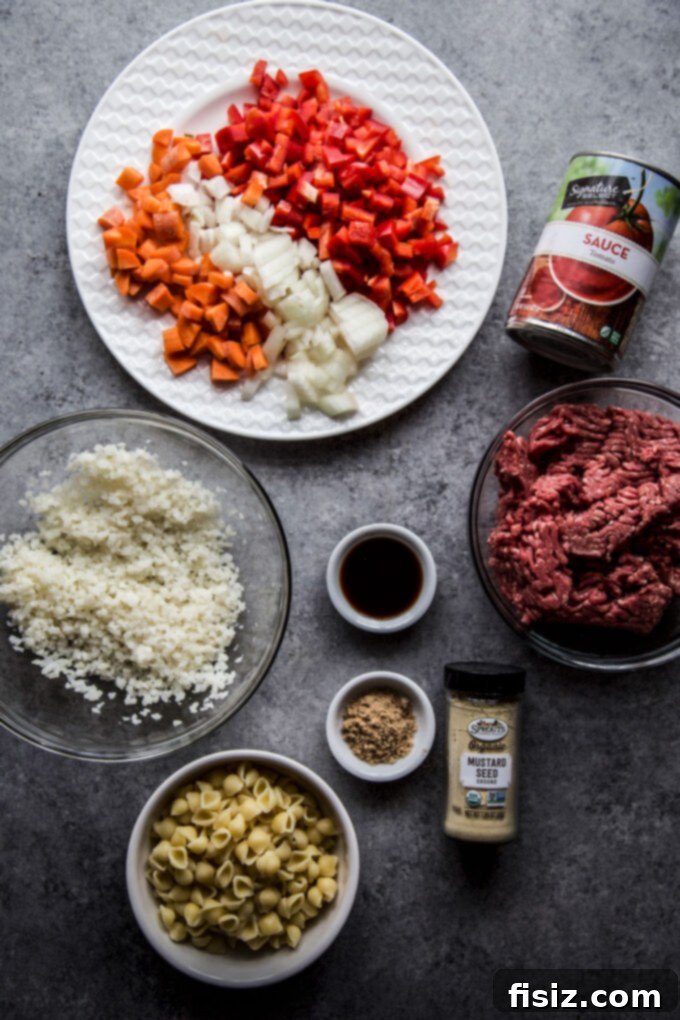 Homestyle Sloppy Joe Turkey Bake 4 Ingredients in bowls on a table - diced veggies, ground beef, tomato sauce, cauliflower rice, spices, and pasta.