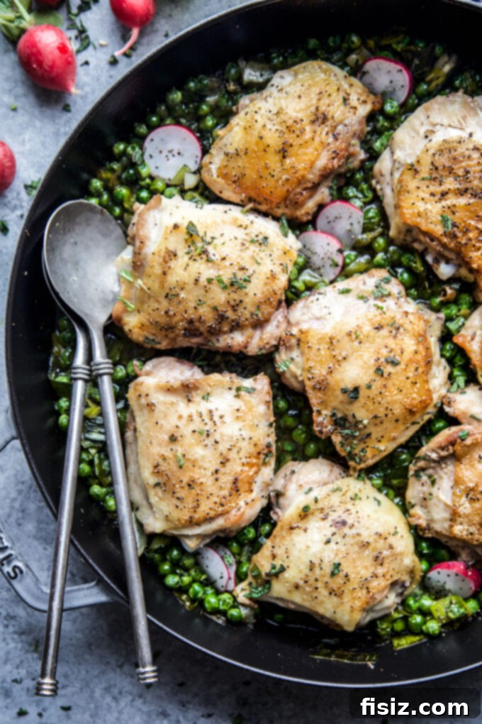Spring-Inspired Chicken Thighs with Mint and Peas 3 Roasted Chicken Thighs with Peas & Mint - A wider shot of the dish, ready to be served, highlighting the golden chicken and colorful vegetables.