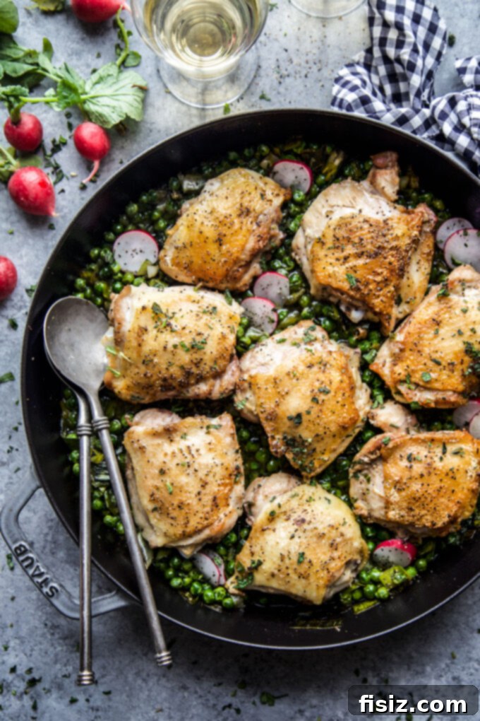 Spring-Inspired Chicken Thighs with Mint and Peas 6 A serving of Roasted Chicken Thighs with Peas & Mint, garnished with fresh mint, ready to be enjoyed.