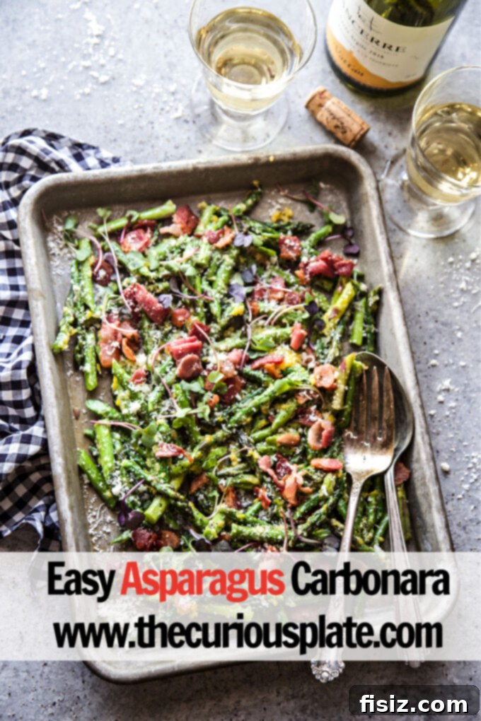 Spring Asparagus Carbonara 8 A close-up of a serving of Easy Asparagus Carbonara, showcasing the vibrant green asparagus, golden bacon, and creamy sauce, sprinkled with fresh black pepper.