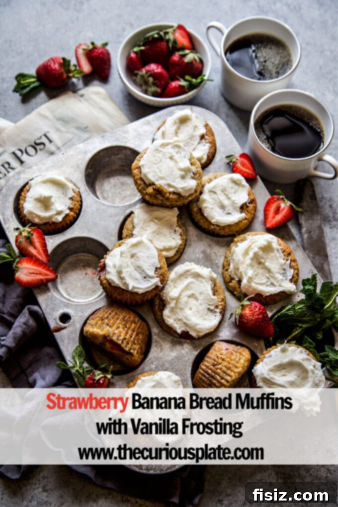 Stacked Strawberry Banana Bread Muffins with Vanilla Frosting on a wooden board