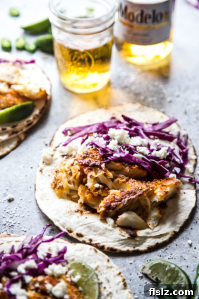 Fish Tacos with a Yucatan Twist 3 Close-up of Yucatan Inspired Fish Tacos, showing shredded fish and fresh toppings