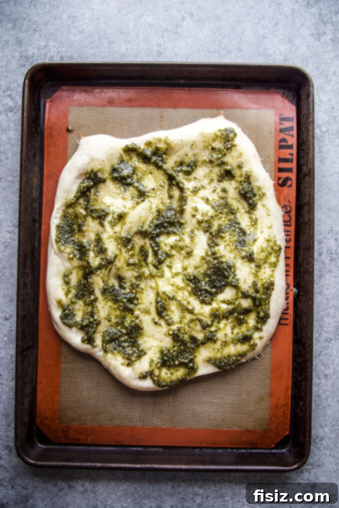 Vibrant Green Goddess Chicken Pizza 5 Pizza crust with pesto sauce spread