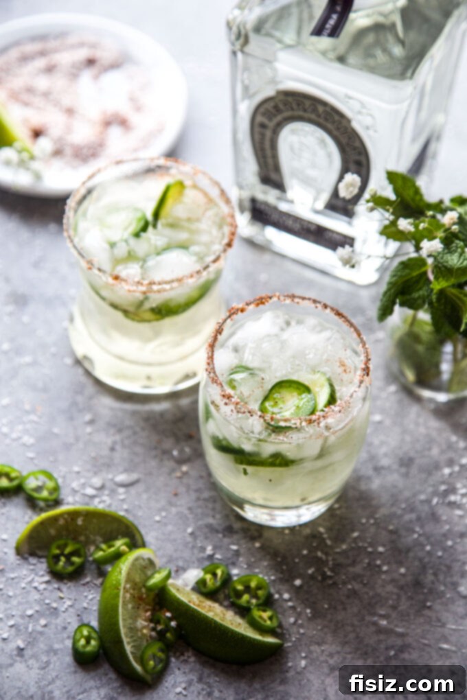 Cucumber Margarita with a Tequila Lime Jalapeño Zing 3 Close-up of a refreshing Spicy Cucumber Margarita, showing the vibrant green hue and intricate garnishes.