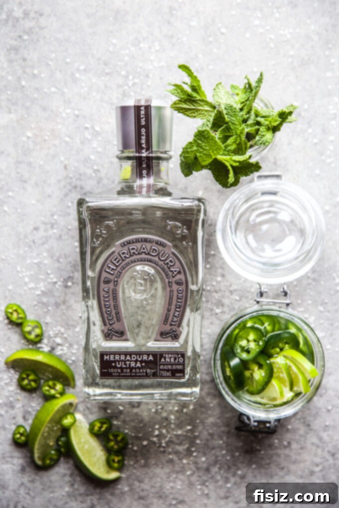 Cucumber Margarita with a Tequila Lime Jalapeño Zing 4 Bottle of Herradura Ultra Cristalino Añejo Tequila, a premium spirit essential for the perfect margarita.
