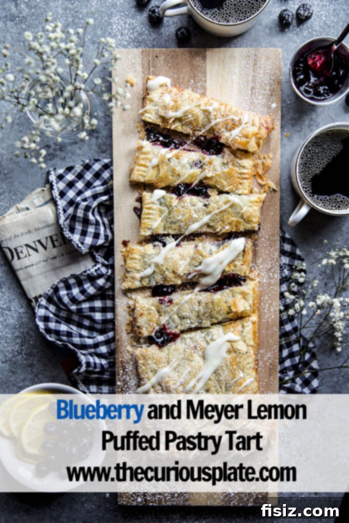 Flaky Blueberry Lemon Pastry 11 A final overhead shot of the elegant Blueberry and Meyer Lemon Puffed Pastry Tart, garnished and ready to be enjoyed.