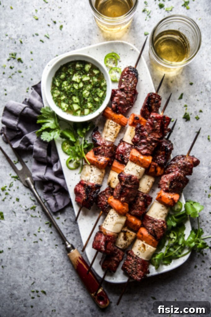 Banh Mi Flavored Beef Skewers 8 Finished Banh Mi Beef Kebabs on a plate with fresh cilantro and lime