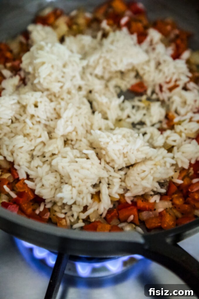 Quick Tuscan Fried Rice 9 Sautéed vegetables and Italian sausage mixed with rice in a large skillet, ready for the final touches.