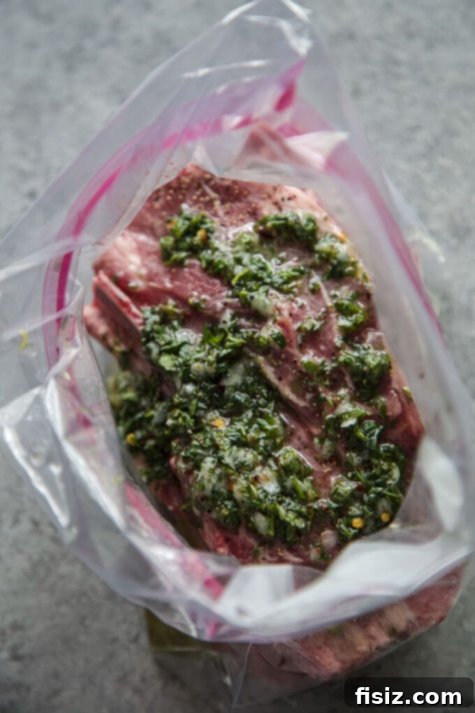 Grilled American Lamb Shoulder Chops, Greek-Style 9 Slicing a cooked Greek Grilled American Lamb Shoulder Chop on a cutting board.