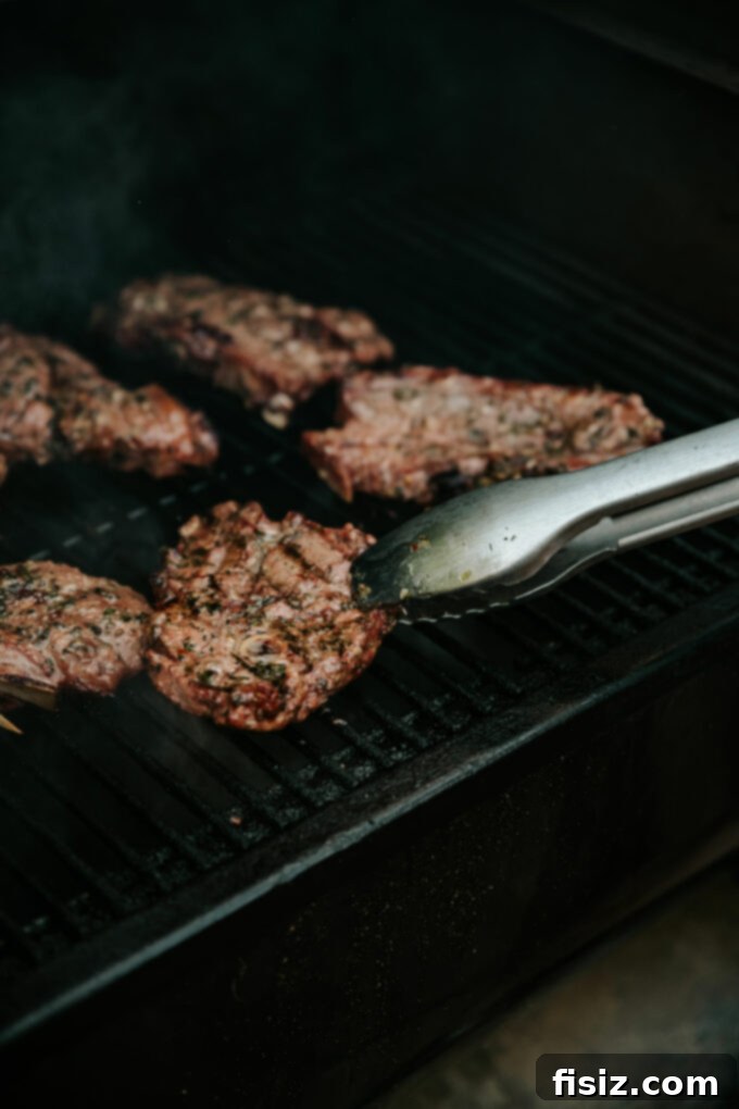 Grilled American Lamb Shoulder Chops, Greek-Style 10 Sliced Greek Grilled American Lamb Shoulder Chops arranged on a serving platter.