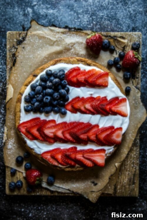 49 Easy Ideas for Your Fourth of July Feast 9 American Flag Cookie Cake with Marshmallow Frosting - A patriotic and delicious centerpiece dessert.