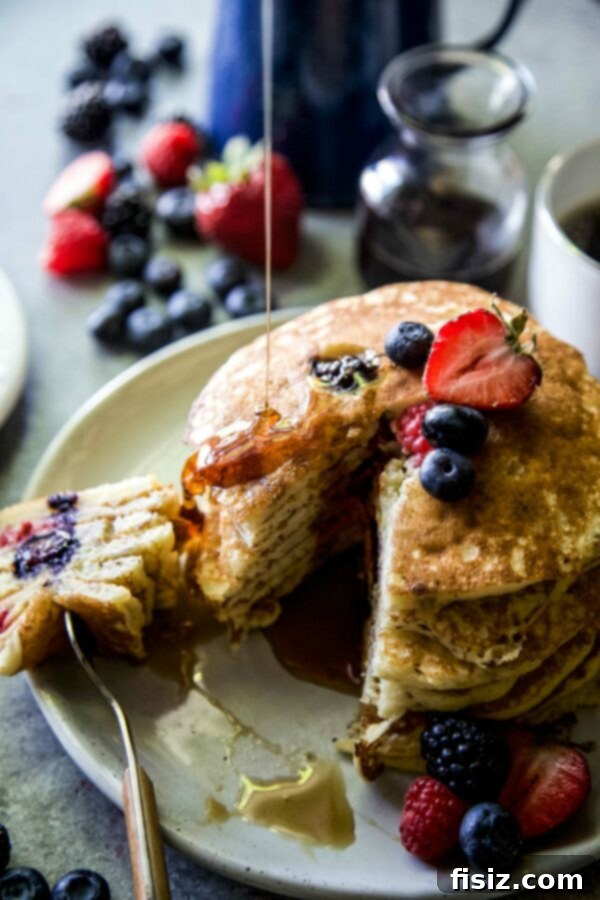 The July Projects I Can't Wait To Start 8 Mixed Berry Almond Pancakes - Fluffy pancakes topped with a colorful assortment of berries.