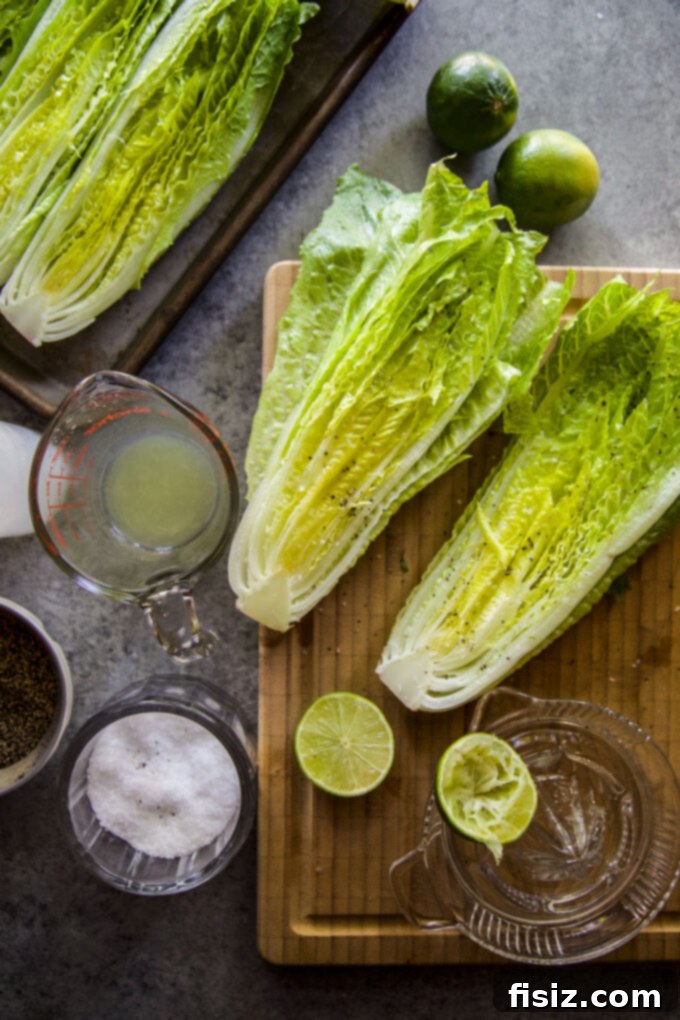 Charred Romaine with Golden Garlic Crumbs 7 Romaine lettuce halves seasoned with olive oil and lime juice on a cutting board.