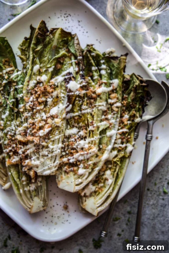 Charred Romaine with Golden Garlic Crumbs 9 Close-up of grilled romaine halves on a serving platter, showing perfect char marks.