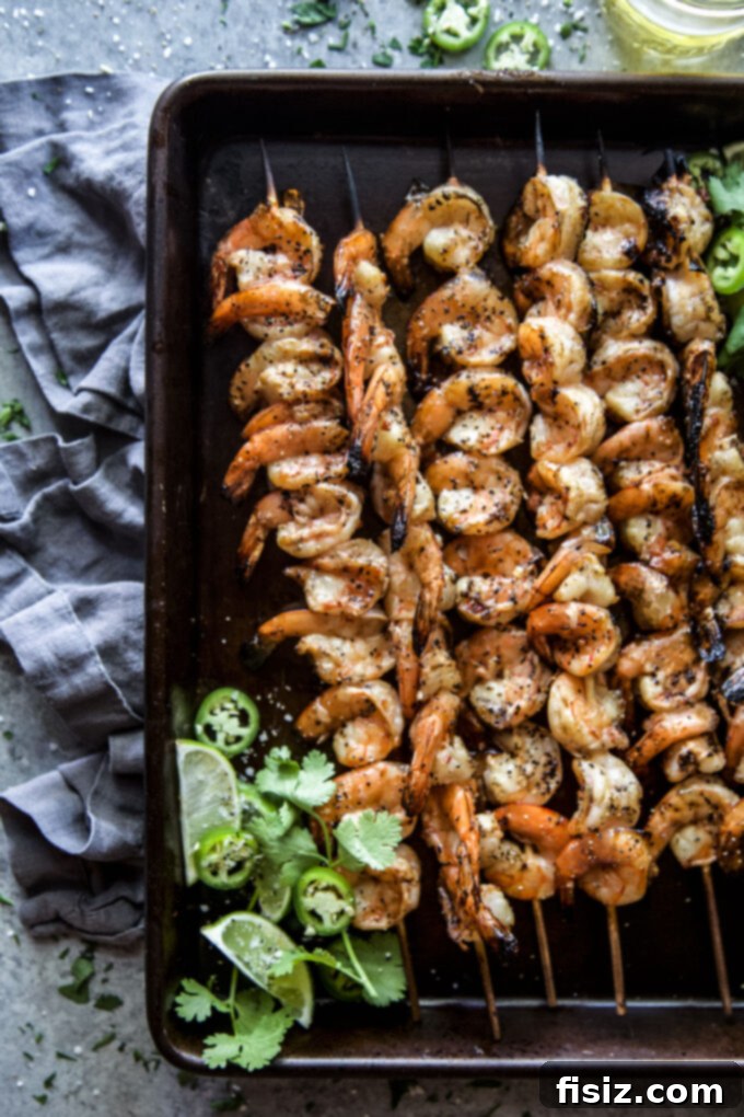 Spicy Citrus Grilled Shrimp Skewers 8 Platter of delicious Grilled Chile Lime Shrimp Skewers with garnishes.