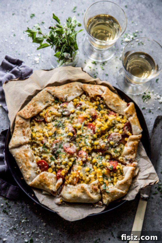 Savory Garden Parmesan Tart 6 A delicious Garden Veggie Parmesan Tart, freshly baked and topped with vibrant vegetables and golden cheese, photographed from above.