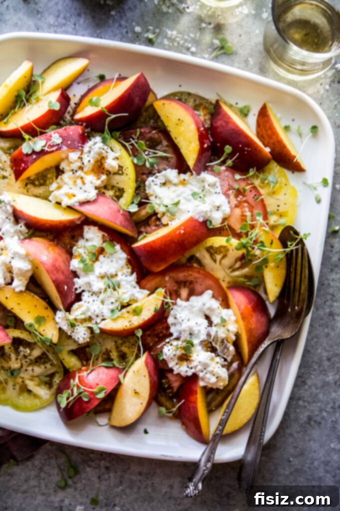 Hot Honey Burrata Salad with Peaches and Tomatoes 2 Vibrant Tomato, Peach, & Burrata Salad with Hot Honey Sauce, garnished with fresh herbs, ready to serve.