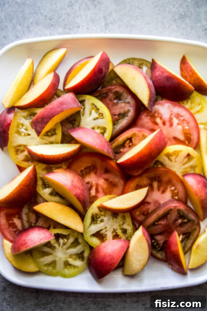Hot Honey Burrata Salad with Peaches and Tomatoes 5 A serving platter with sliced tomatoes and peaches, waiting for burrata and hot honey sauce.