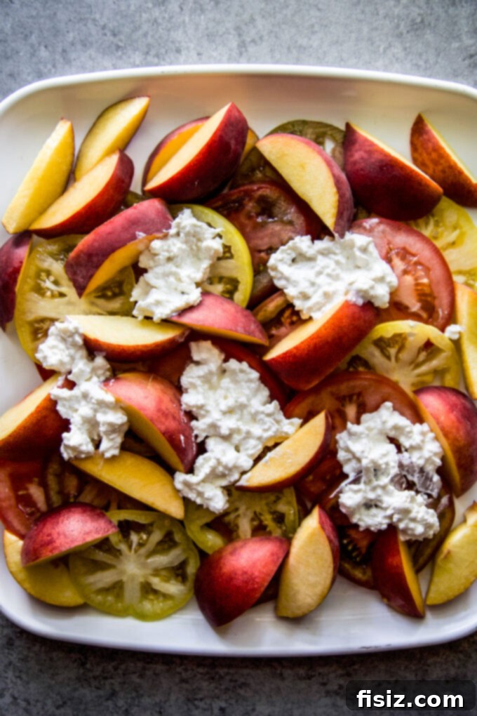 Hot Honey Burrata Salad with Peaches and Tomatoes 6 Another perspective of the fresh tomatoes and peaches arranged on a serving plate for the salad.
