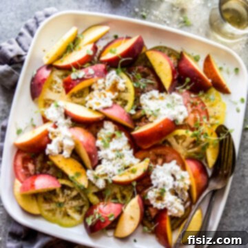Hot Honey Burrata Salad with Peaches and Tomatoes 9 Tomato, Peach, & Burrata Salad with Hot Honey Sauce on a plate