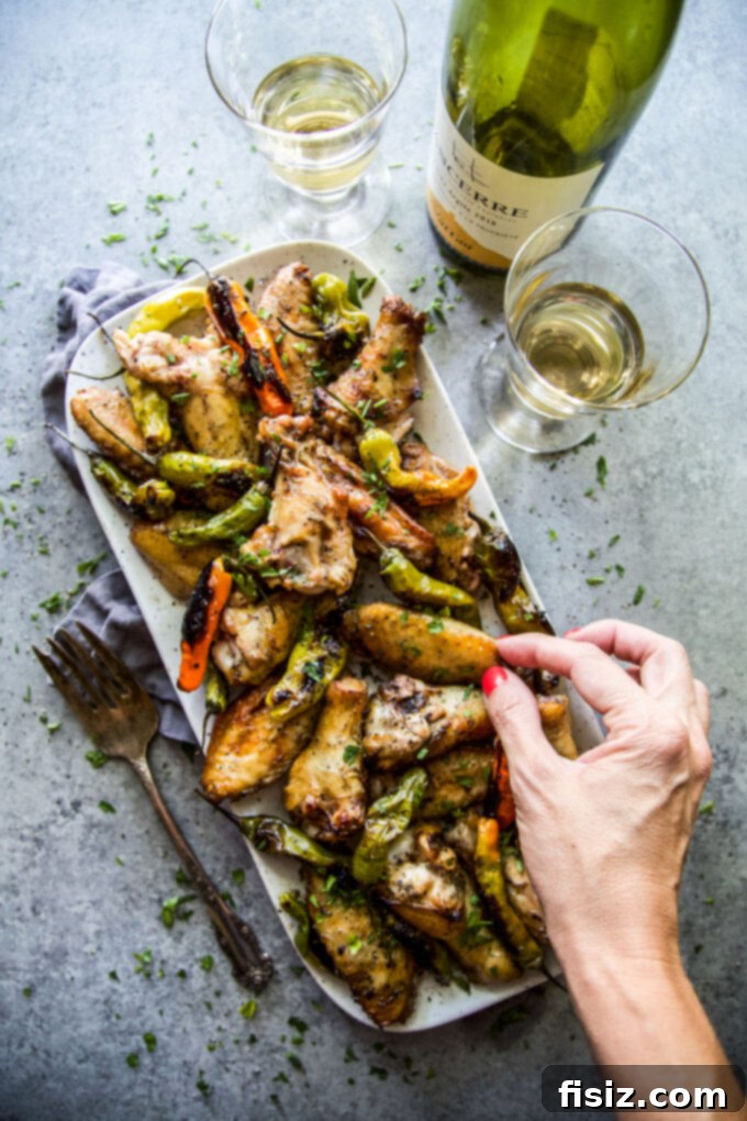 Tangy Lemon-Garlic Wings & Charred Shishitos 7 Platter of Lemon Garlic Grilled Chicken Wings with Shishito Peppers, garnished with fresh parsley