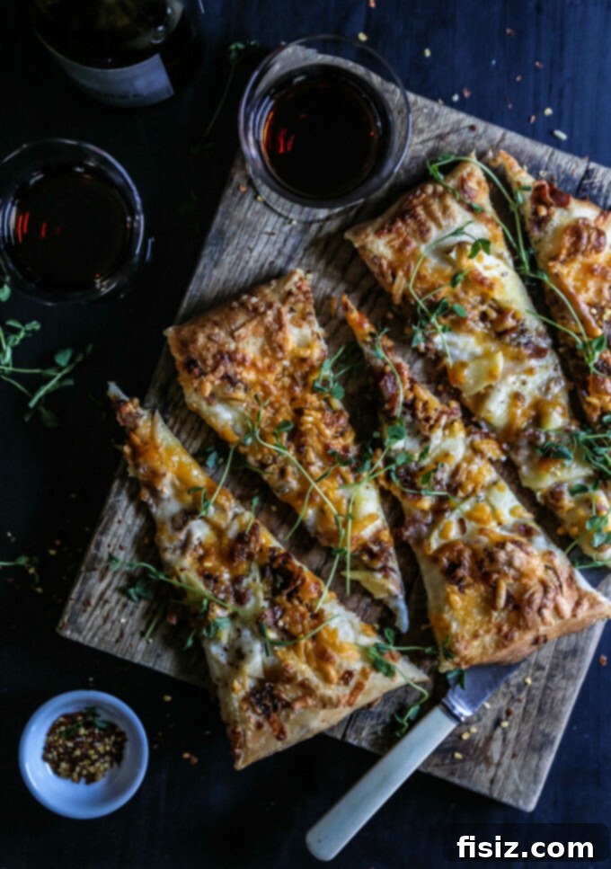 28 Irresistible Apple Recipes to Make Today 4 Apple Cheddar Rosemary Pizza - A savory and sweet pizza with bacon and fresh apples.