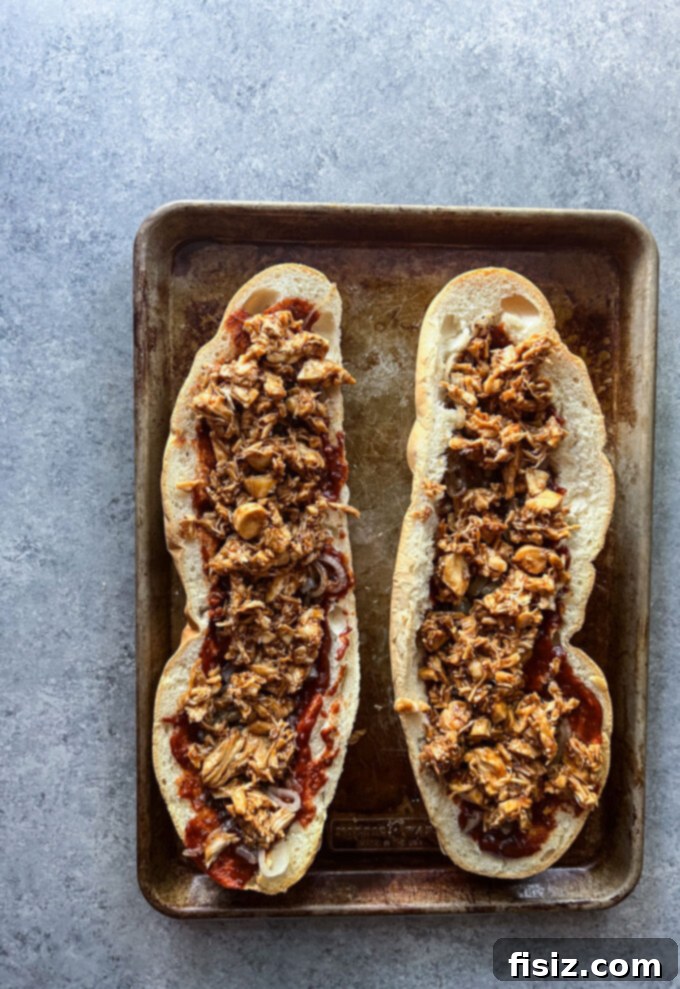 Smoked Mozzarella BBQ Chicken Baguette Pizza 9 Baguette halves toasting cut-side up on a baking sheet