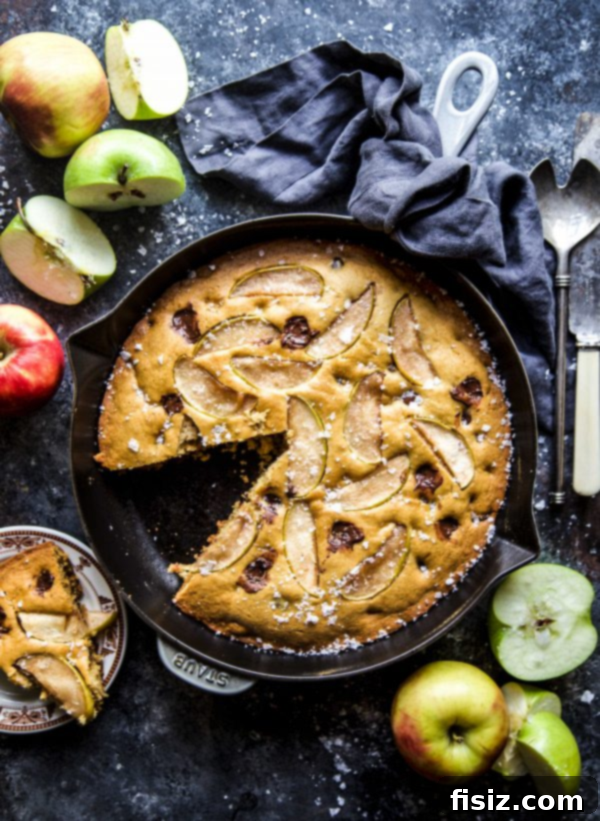 Our Top 30 Cozy Fall Recipes 7 Salted Chocolate Chip Apple Skillet Cookie, a warm and comforting fall dessert, served with ice cream.