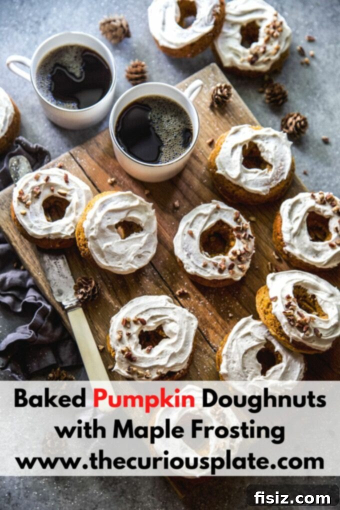 Maple Kissed Baked Pumpkin Doughnuts 11 Baked Pumpkin Doughnuts with Maple Frosting and Pecans on a wooden board