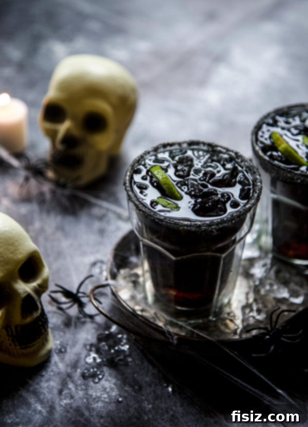 Wickedly Easy Halloween Bites 2 A vibrant selection of Halloween-themed dishes, featuring a spooky charcuterie board, festive drinks, and delicious desserts, all part of an easy Halloween recipes collection.