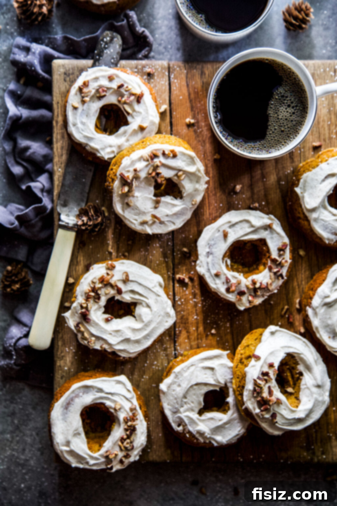 Whip Up These 27 Pumpkin Recipes Today 8 Delicious Baked Pumpkin Doughnuts with Maple Frosting, a perfect sweet treat for any occasion.