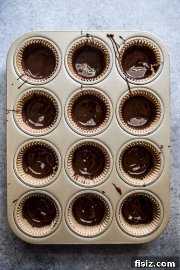 Wicked Good Halloween Dark Chocolate Peanut Butter Cups 5 Three Homemade Dark Chocolate Peanut Butter Cups with festive Halloween sprinkles, showcasing the final delicious product.