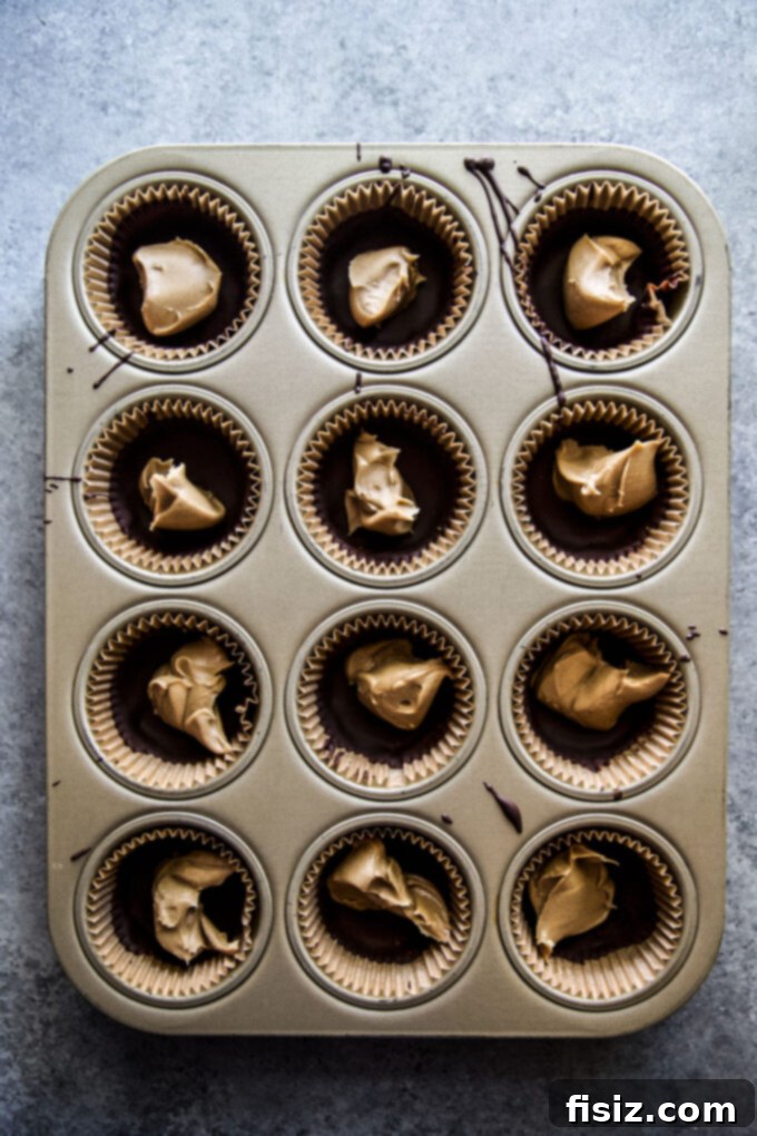 Wicked Good Halloween Dark Chocolate Peanut Butter Cups 6 A close-up of a decorated Homemade Dark Chocolate Peanut Butter Cup, emphasizing its rich texture and Halloween flair.