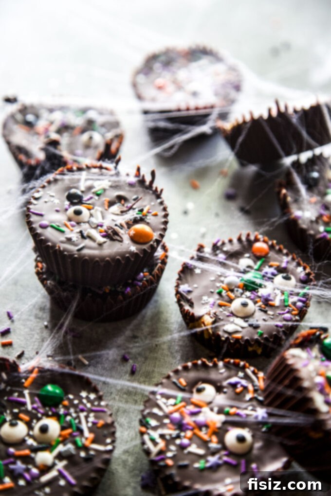 Wicked Good Halloween Dark Chocolate Peanut Butter Cups 8 A freshly made Homemade Dark Chocolate Peanut Butter Cup, showcasing its perfect layers and festive Halloween sprinkles.