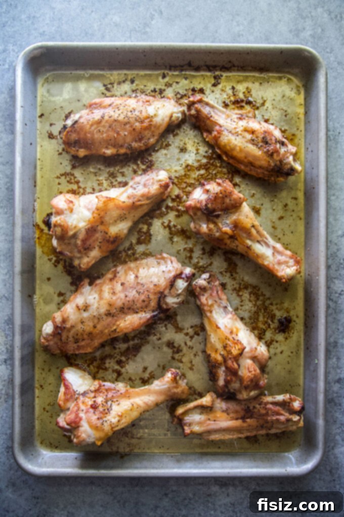 Simple Homemade Turkey Stock 5 Golden-brown roasted turkey wings on a sheet pan