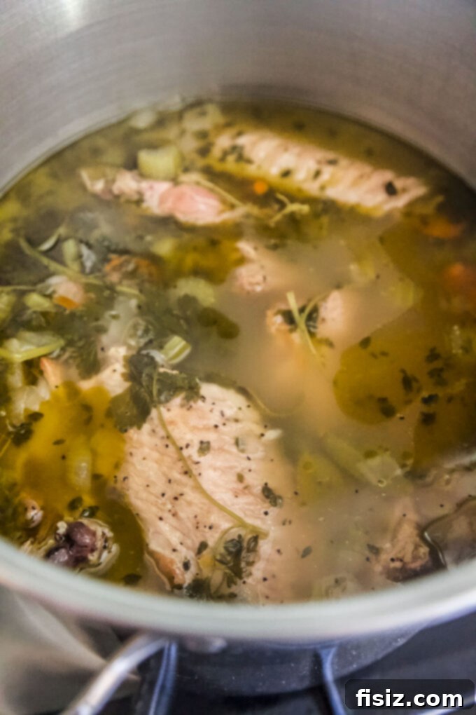 Simple Homemade Turkey Stock 8 Turkey stock gently simmering on the stovetop