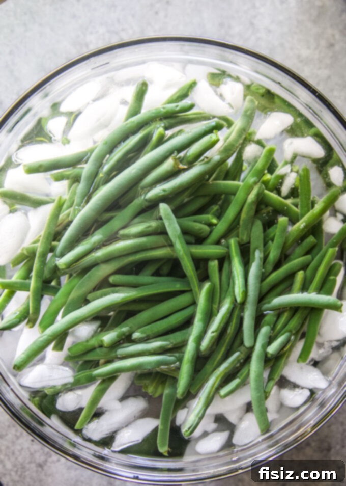 One-Pan Green Bean Casserole 6 blanched green beans cooling in an ice bath