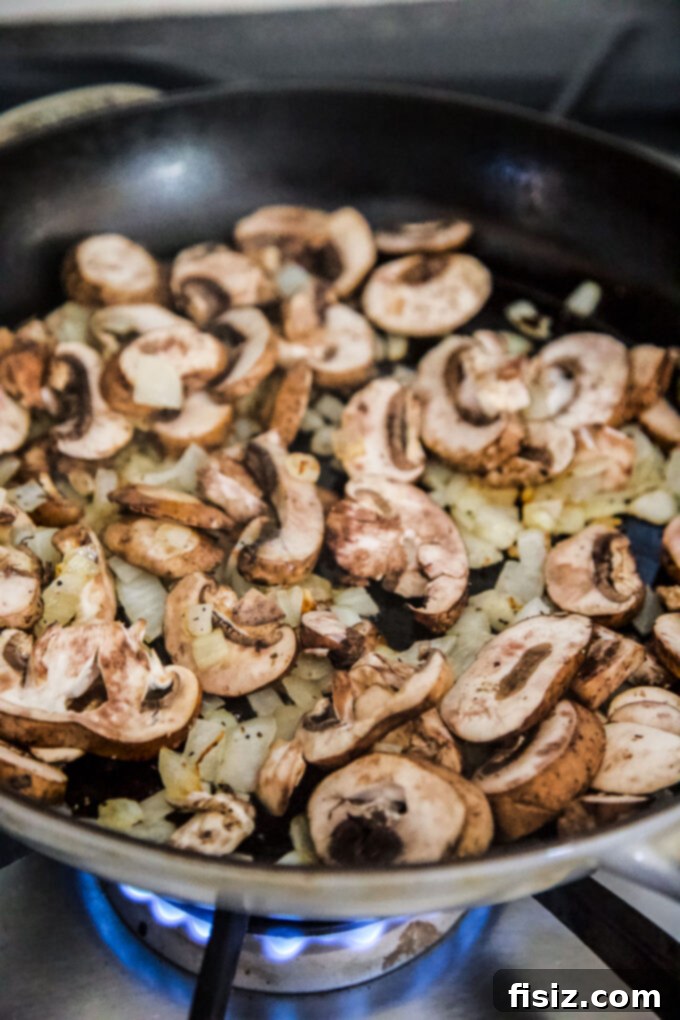 One-Pan Green Bean Casserole 7 diced onions and sliced mushrooms sautéing in a skillet