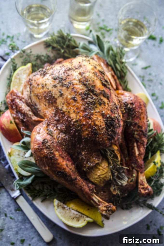 Easy Herb Butter Roasted Turkey 9 Perfectly roasted turkey with herb butter, resting on a cutting board