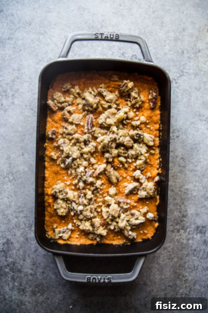 Old-fashioned sweet potato casserole with streusel topping before baking.