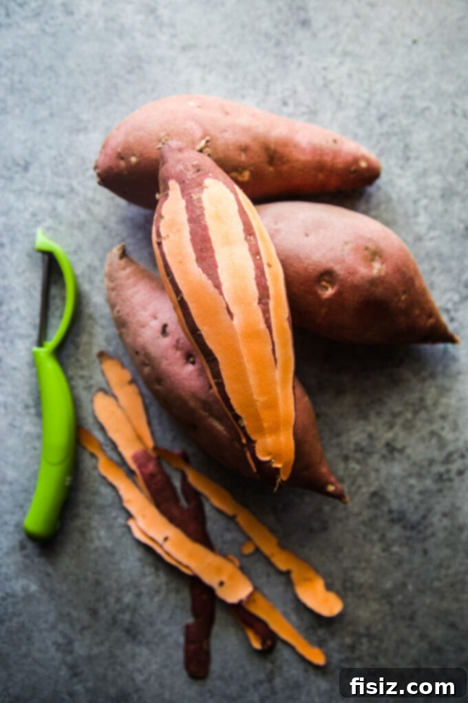 Close-up of chopped sweet potatoes and a stick of butter for the casserole.