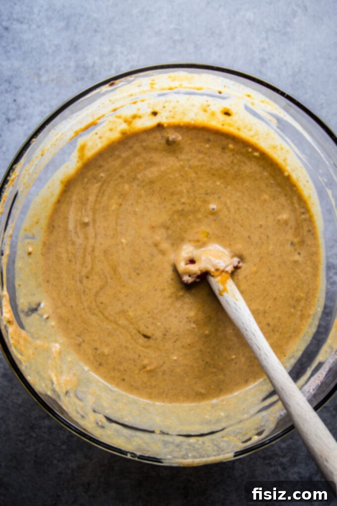 Gingersnap-Crusted Pumpkin Pie with Candied Pepitas 7 Whisking in eggs and heavy cream to create a smooth pumpkin pie filling.