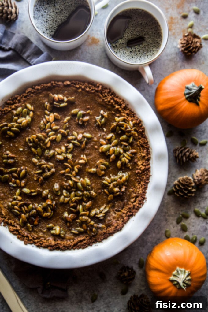 Gingersnap-Crusted Pumpkin Pie with Candied Pepitas 9 Assembled Pumpkin Pie with Gingersnap Crust and Candied Pepitas, ready for baking.