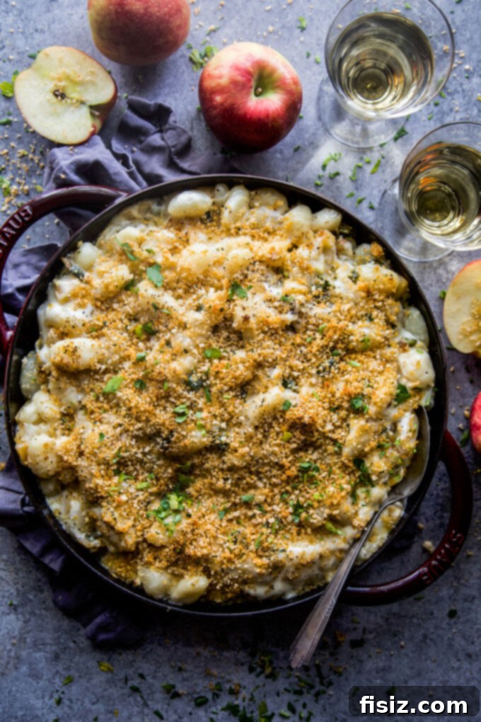Smoky Cheddar Apple and Poblano Gnocchi Bake 2 A close-up of the Apple & Poblano Gnocchi Bake with Smoked Cheddar Cheese, featuring golden brown topping and visible apple and pepper pieces.