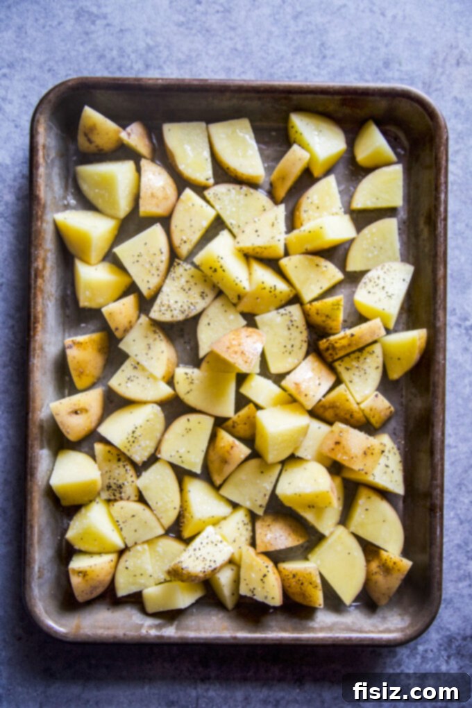 Sausage and Apple Hash with Zesty Whole Grain Mustard 4 potatoes on a baking sheet
