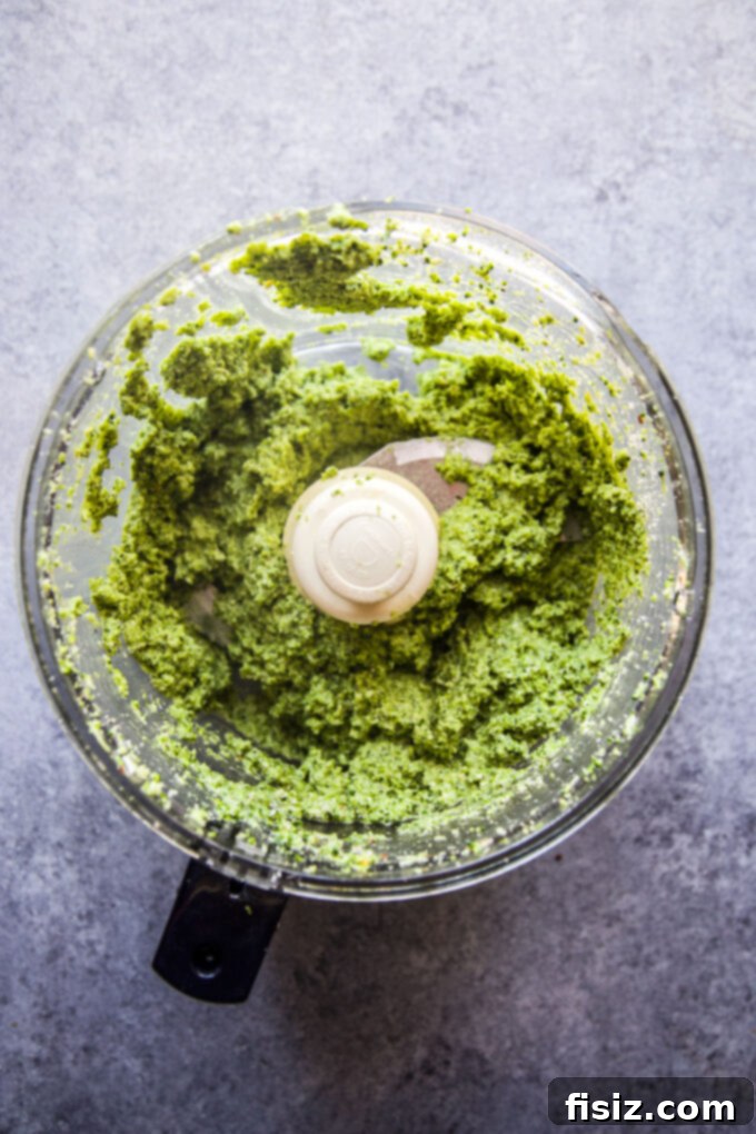 Vibrant Broccoli Walnut Pesto Pasta 6 Close-up of a serving fork twirling Broccoli Walnut Pesto Pasta
