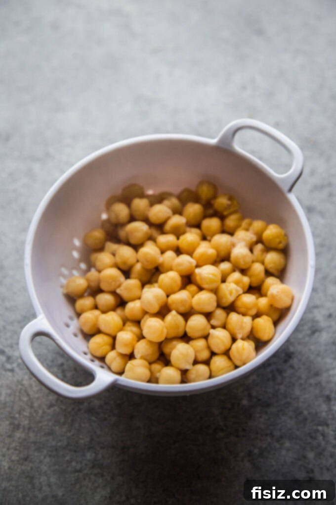 Zesty Lemon Garlic Chicken Meatballs with Creamy Hummus 6 Canned chickpeas in a glass bowl, ready to be used for homemade hummus.