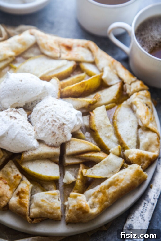 Rustic Cardamom Pear Galette 3 Close-up of a golden-brown Cardamom Pear Galette with its rustic folded crust