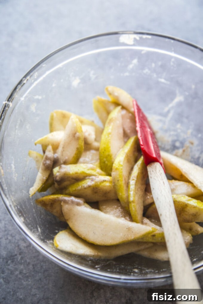 Rustic Cardamom Pear Galette 5 A bowl of sliced pears tossed with sugar, cardamom, and lemon juice for the galette filling