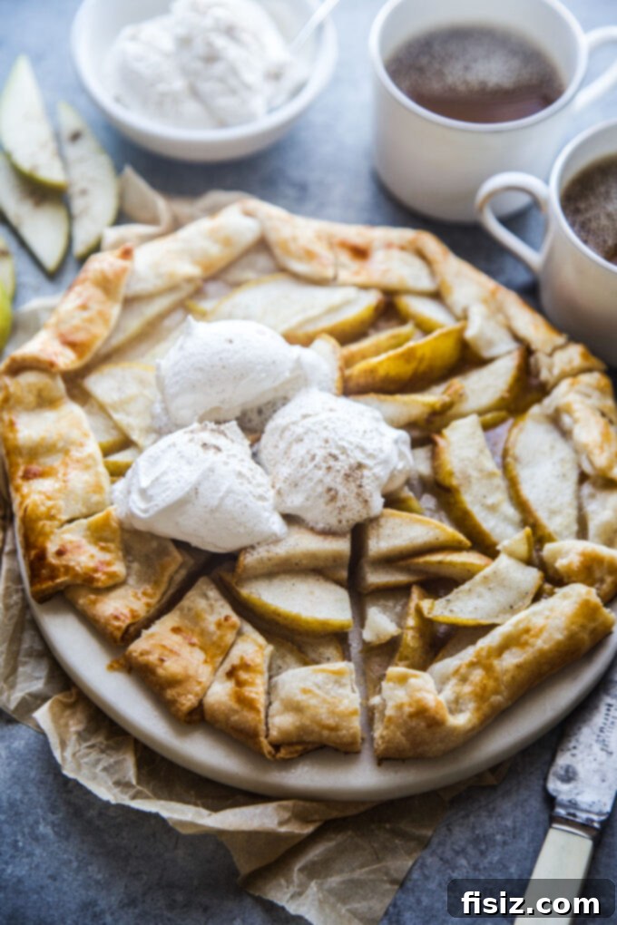 Rustic Cardamom Pear Galette 6 Freshly baked Cardamom Pear Galette cooling on a wire rack, steam gently rising